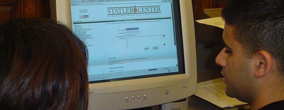 A Male and female student are exploring the Stater Center website. 